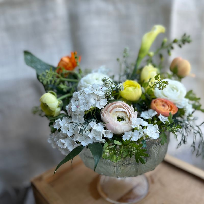 Decorative funeral arrangement in white and yellow